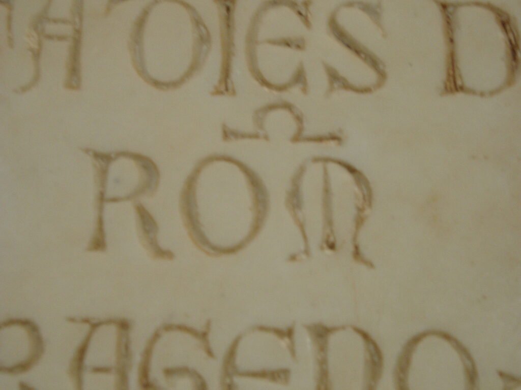 Inscription featuring the name "ROMA," highlighting ancient Roman identity and cultural significance in classical studies.